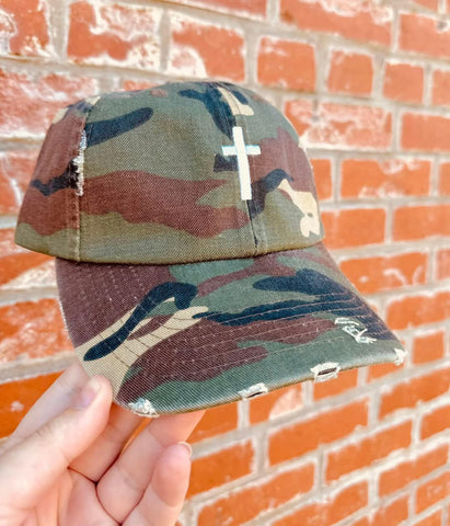 Distressed Camo Cross Hat - Style & Grace Co Distressed camo baseball hat with white embroidered cross on front"

"Christian cross camouflage cap with adjustable leather strap"

"Vintage style camo hat featuring faith-based cross design"

"Unisex distressed camo cross hat for casual and faith fashion"

"Faith-inspired camouflage baseball cap with worn look"

"Christian camo hat with embroidered white cross and brass buckle"

"Stylish religious camo cap with vintage distressed fabric"

"Adjustable camouflage